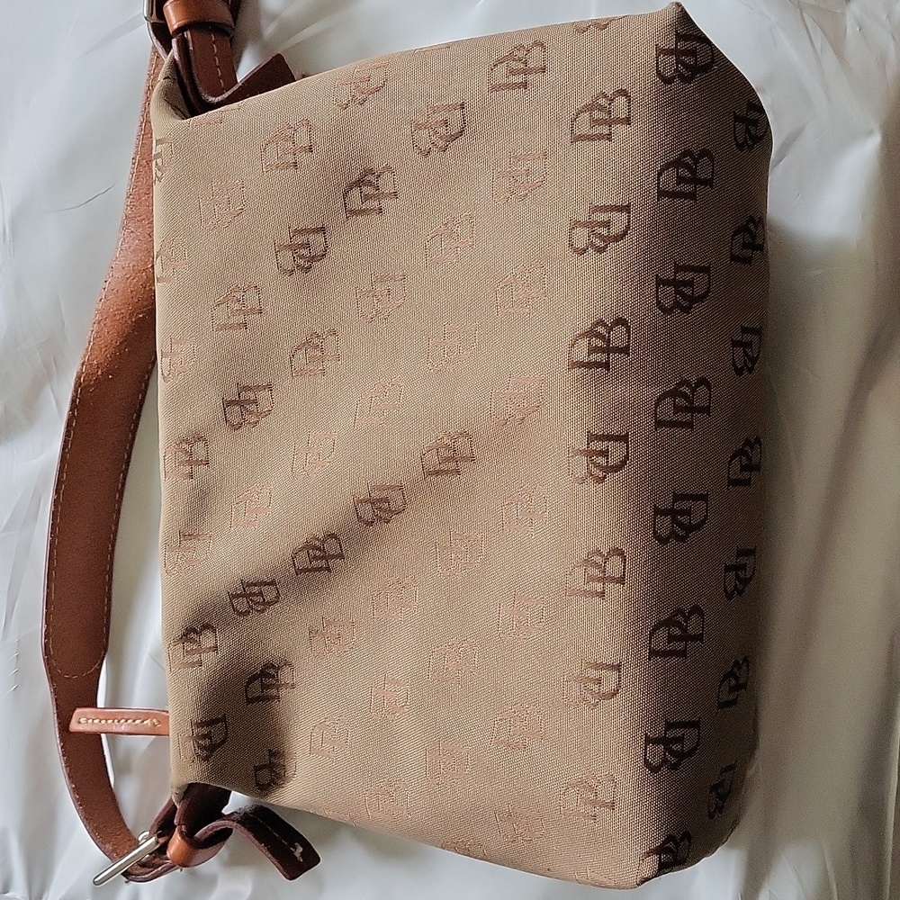 DOONEY AND BOURKE tan with leather strap and signature DB on purse. Like new